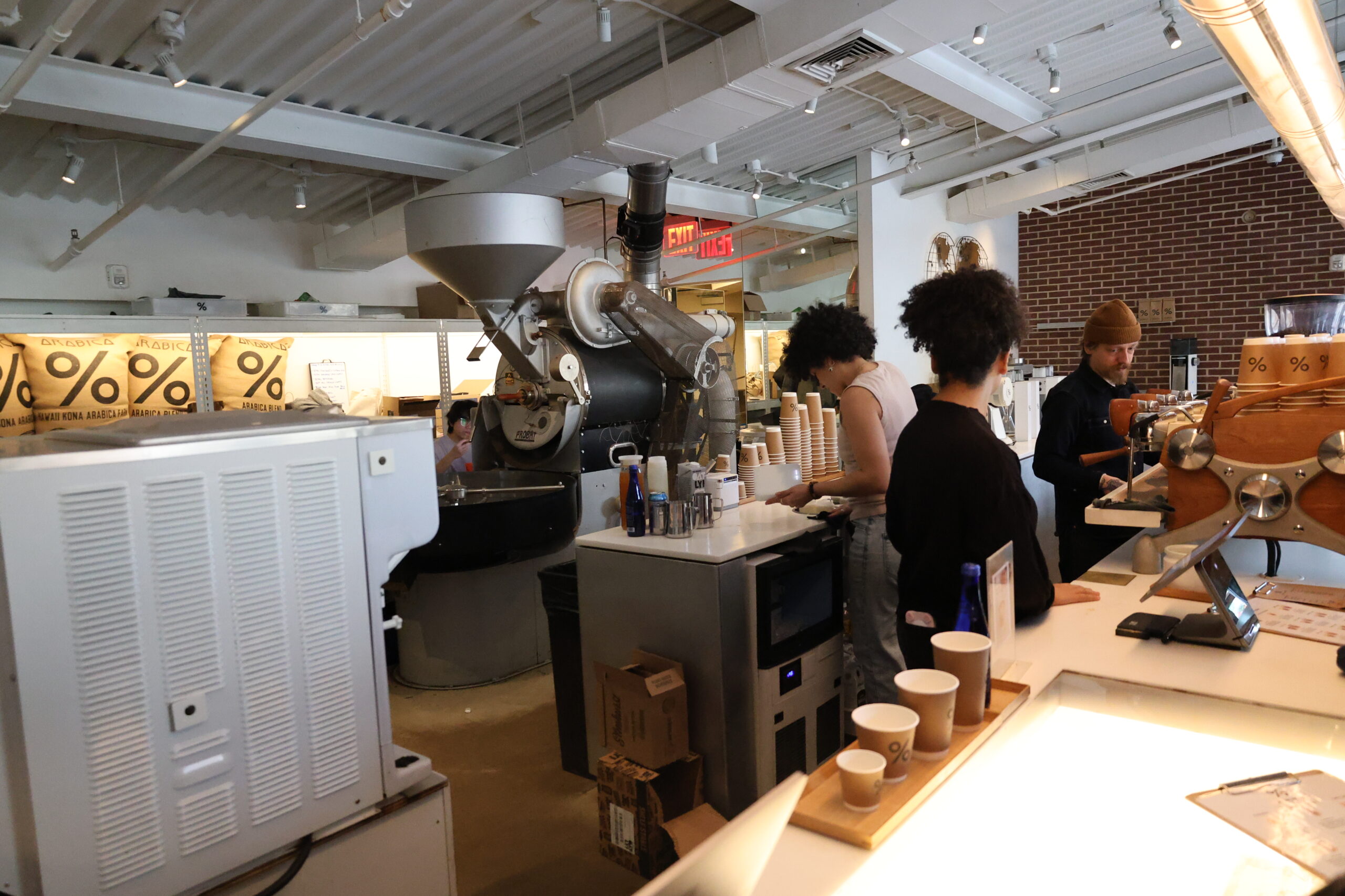 Coffee Roaster Behind the Espresso Bar at a % Arabica Café